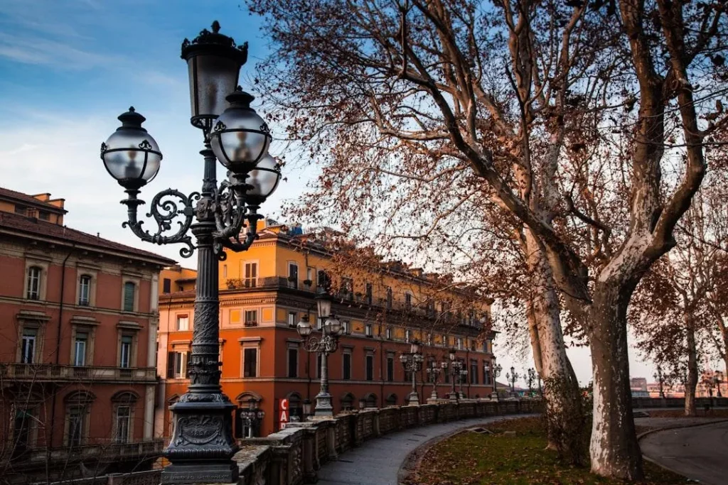 A quiet historic canal running past old brick buildings in Bologna